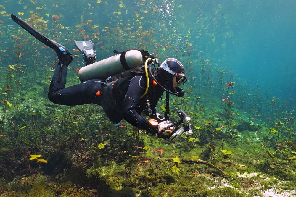 Scuba diver taking photos underwater