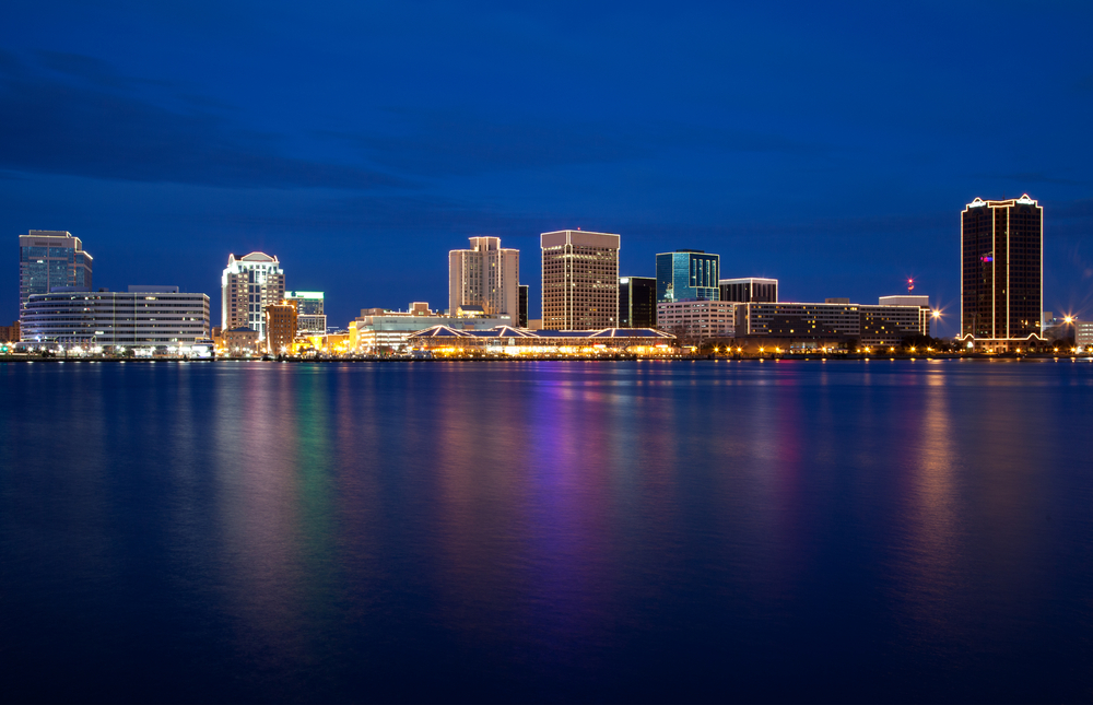 Night time view of Norfolk, Virginia skyline reflecting on water