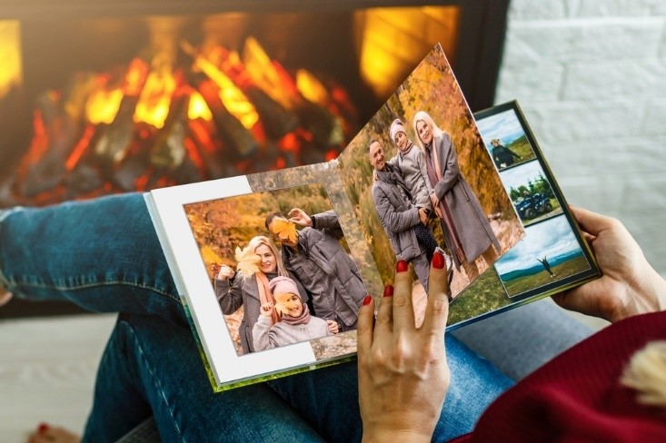 young family photos in picture book in the fall with fireplace