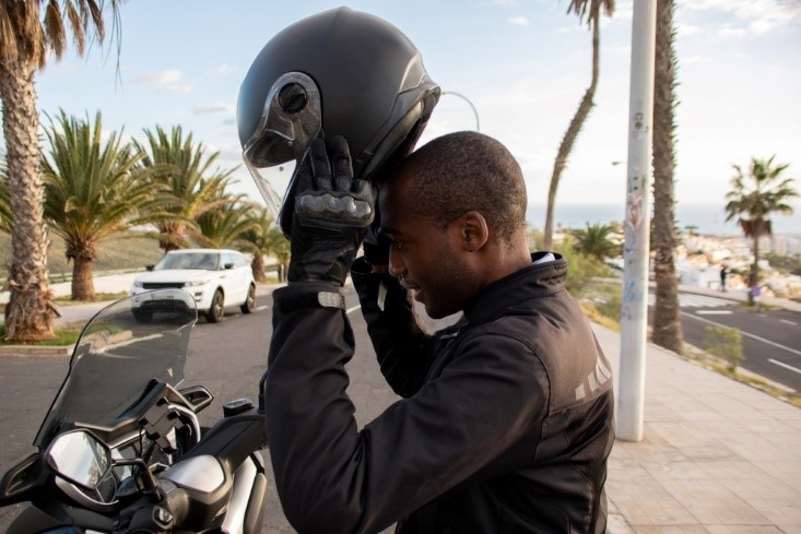 african american man putting on motorcycle helmet