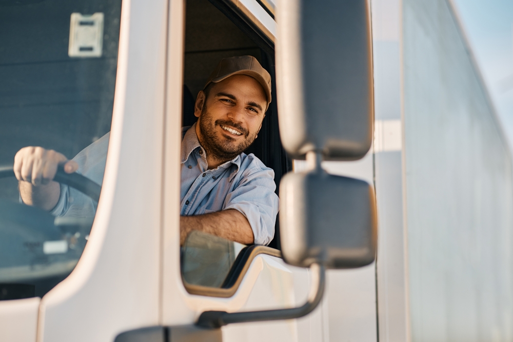 Happy professional truck driver smiling