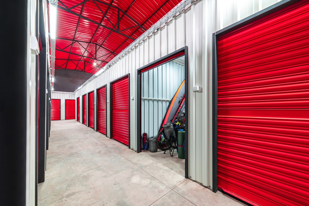 Corridor of self storage facility with red doors